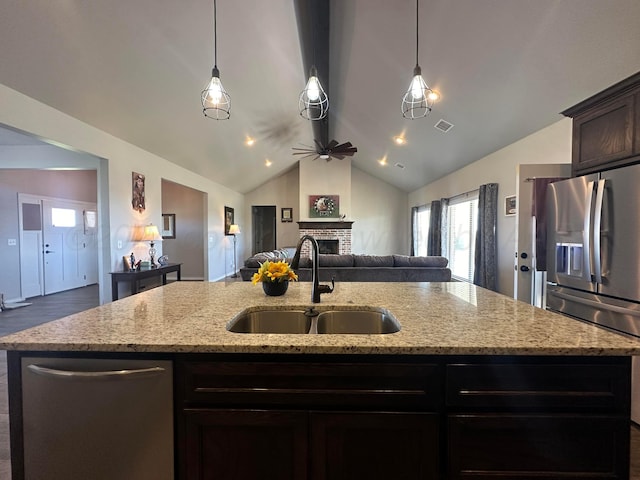 17901 19th St, Amarillo, TX 79124 - kitchen with a sink, stainless steel appliances, open floor plan, a fireplace, and a kitchen island with sink