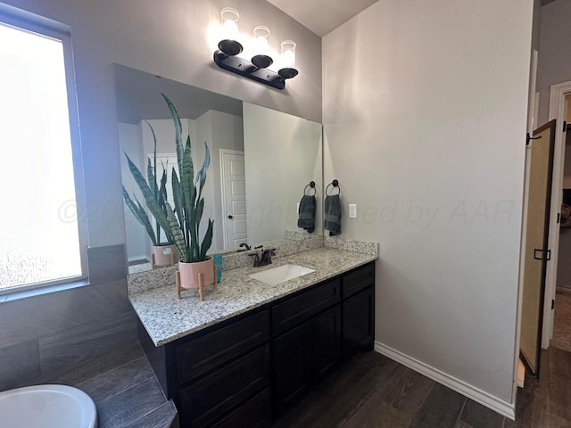 17901 19th St, Amarillo, TX 79124 - bathroom featuring vanity, wood finished floors, and baseboards