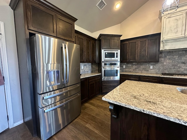 17901 19th St, Amarillo, TX 79124 - kitchen featuring appliances with stainless steel finishes, lofted ceiling, dark brown cabinetry, backsplash, and dark wood-type flooring