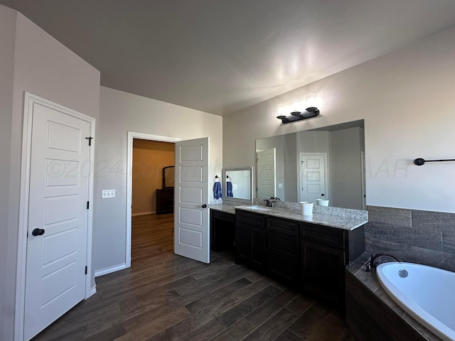 17901 19th St, Amarillo, TX 79124 - full bathroom featuring a garden tub, wood finished floors, vanity, and baseboards
