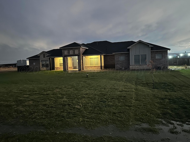 17901 19th St, Amarillo, TX 79124 - view of front of house featuring brick siding, a front lawn, and board and batten siding