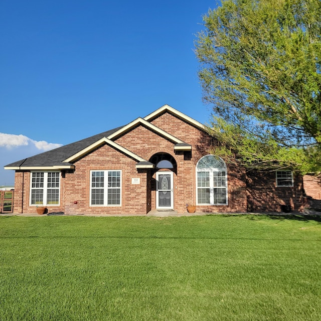 ranch-style home with a front lawn and brick siding
