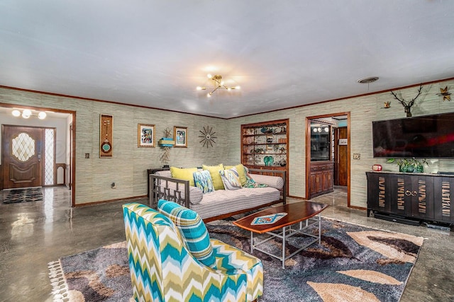 living room with an inviting chandelier and concrete floors