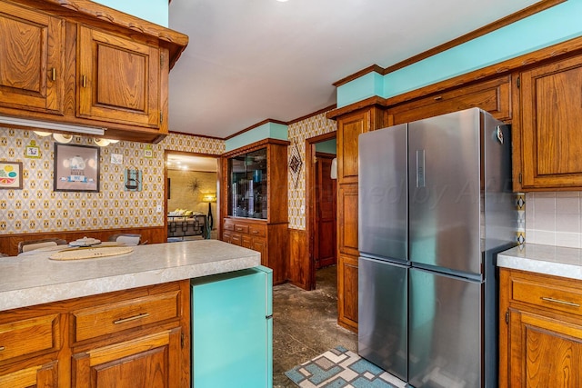 kitchen featuring ornamental molding and stainless steel fridge