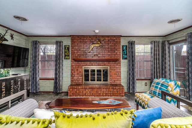 living room featuring a fireplace, carpet flooring, crown molding, and plenty of natural light