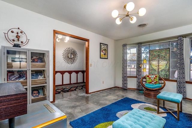 living area featuring carpet and an inviting chandelier