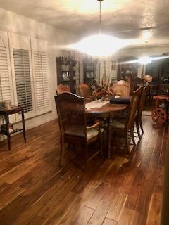 dining room with dark wood-type flooring