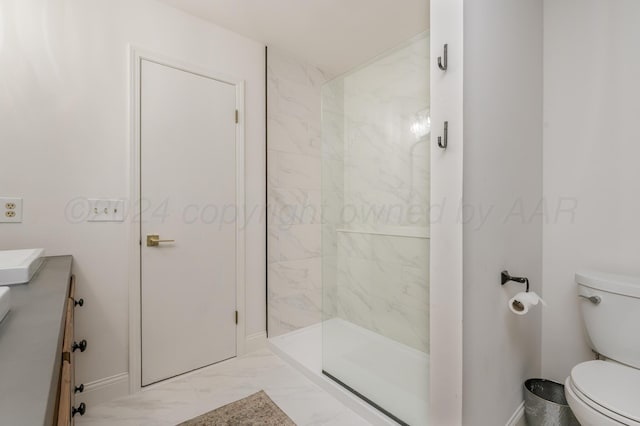 bathroom featuring vanity, baseboards, toilet, marble finish floor, and a tile shower