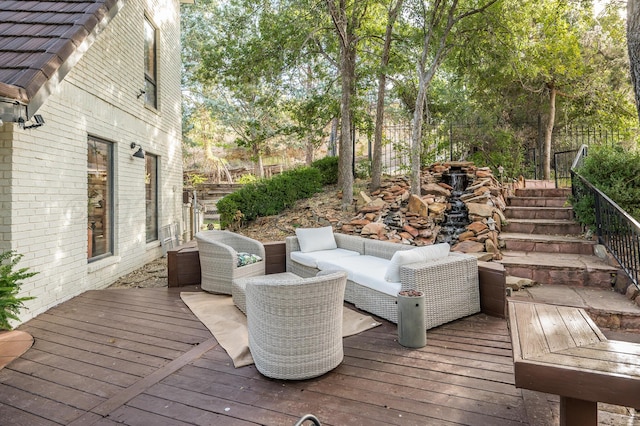 deck with an outdoor hangout area and fence