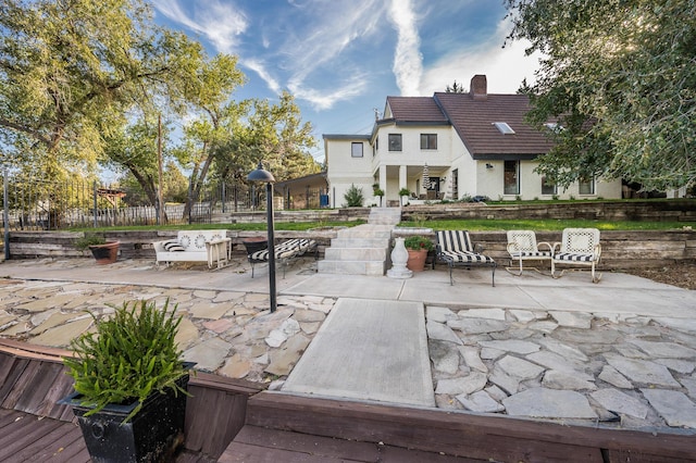 view of property's community featuring fence and a patio