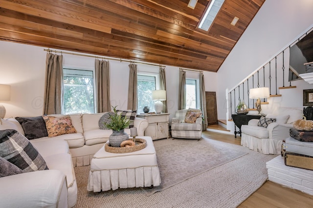 living area featuring wooden ceiling, wood finished floors, vaulted ceiling, and stairs