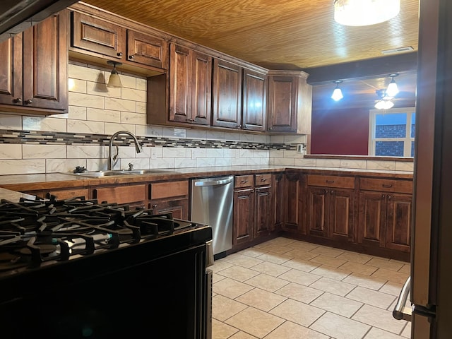 505 S Denton St, Booker, TX 79005 - kitchen featuring stainless steel dishwasher, black gas range, decorative backsplash, light tile patterned floors, and dark countertops