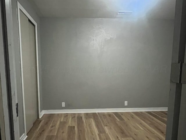 505 S Denton St, Booker, TX 79005 - unfurnished bedroom featuring light wood-style floors and a closet