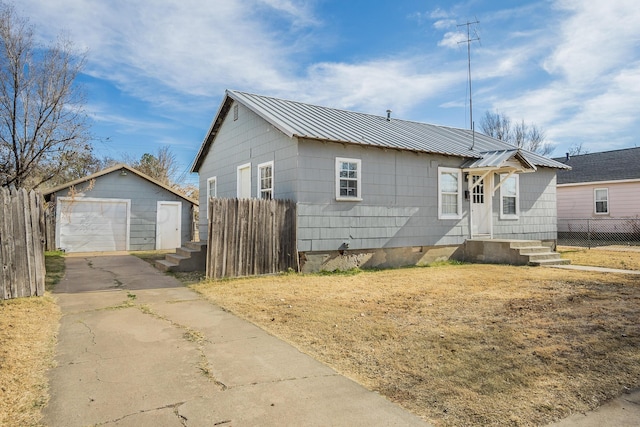 420 N Nelson St, Pampa, TX 79065 - bungalow featuring driveway, fence, an outdoor structure, metal roof, and a garage