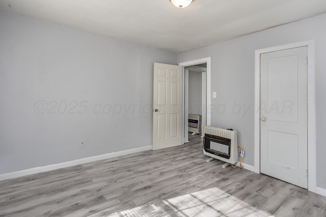 420 N Nelson St, Pampa, TX 79065 - unfurnished bedroom featuring heating unit, baseboards, and light wood-style floors