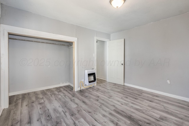 420 N Nelson St, Pampa, TX 79065 - unfurnished bedroom with heating unit, baseboards, a closet, and wood finished floors