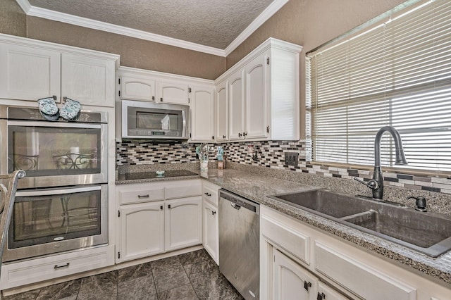kitchen with tasteful backsplash, a sink, crown molding, and appliances with stainless steel finishes