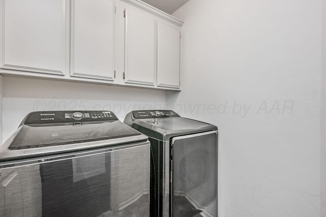 clothes washing area with cabinet space and washing machine and clothes dryer