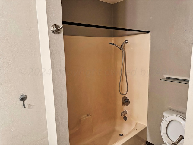 bathroom with toilet and tub / shower combination