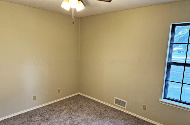 carpeted spare room with ceiling fan