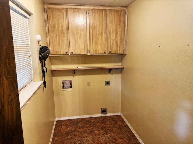 laundry room with hookup for an electric dryer, washer hookup, and cabinets