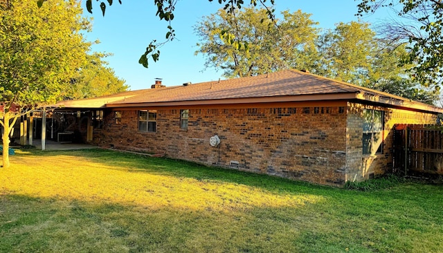 view of home's exterior featuring central air condition unit, a yard, and a patio area