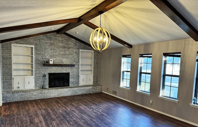 unfurnished living room with vaulted ceiling with beams, a notable chandelier, a textured ceiling, dark hardwood / wood-style floors, and built in features