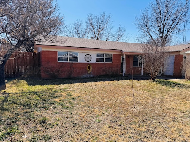 single story home featuring brick siding, a front lawn, and fence