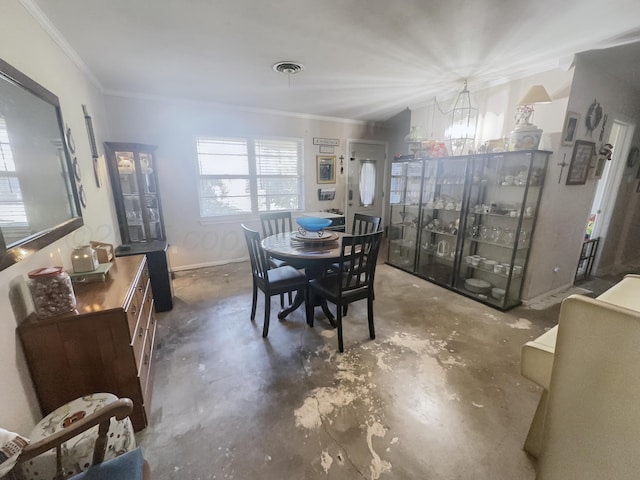 dining room with a notable chandelier, concrete floors, visible vents, baseboards, and crown molding