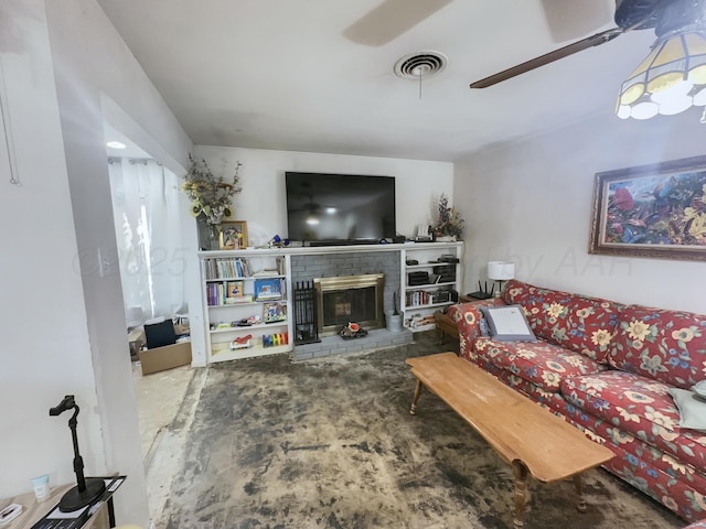 living area featuring ceiling fan, a brick fireplace, and visible vents