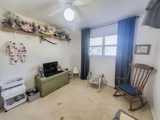 interior space with carpet flooring and a ceiling fan