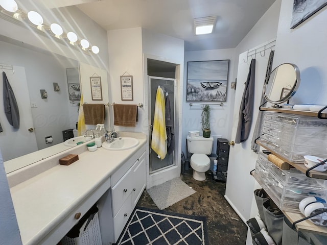 bathroom featuring toilet, a shower stall, and vanity