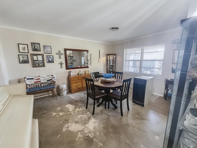 dining space with baseboards, visible vents, concrete flooring, and ornamental molding