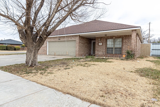 3301 S Birmingham St, Amarillo, TX 79103 - view of front facade with brick siding, driveway, a garage, and a shingled roof