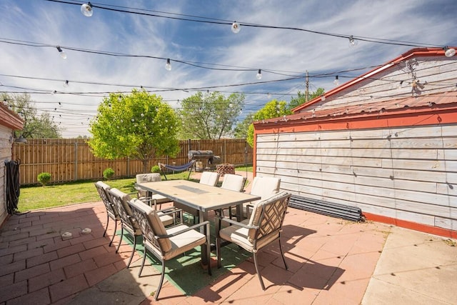 view of patio with a fenced backyard and outdoor dining space