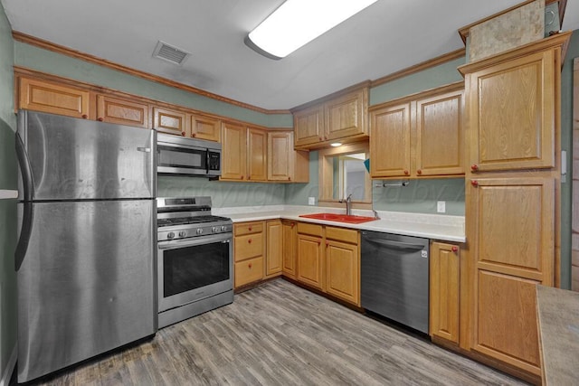 kitchen with light countertops, visible vents, appliances with stainless steel finishes, and a sink