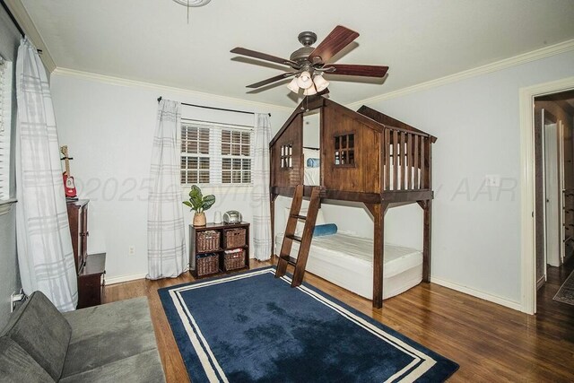 bedroom featuring baseboards, ornamental molding, and wood finished floors