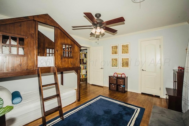bedroom featuring crown molding, baseboards, and wood finished floors