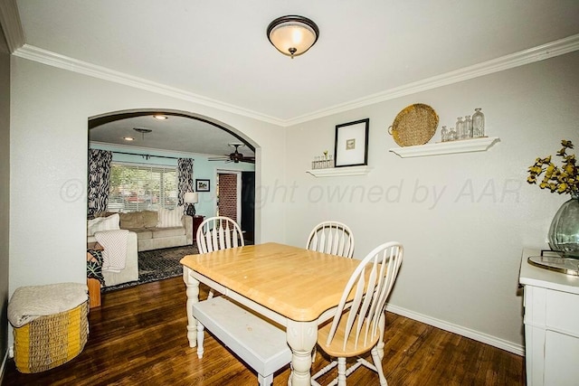 dining space with arched walkways, wood finished floors, and ornamental molding