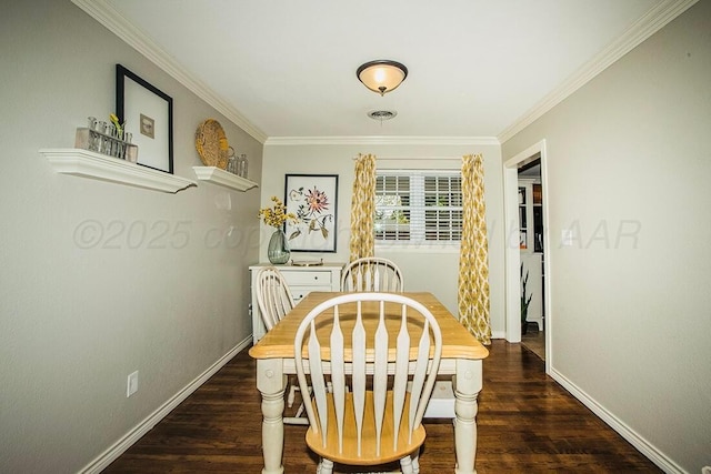 dining area featuring baseboards, ornamental molding, and wood finished floors