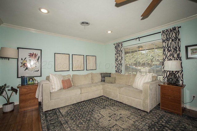 living room featuring crown molding, a ceiling fan, and baseboards