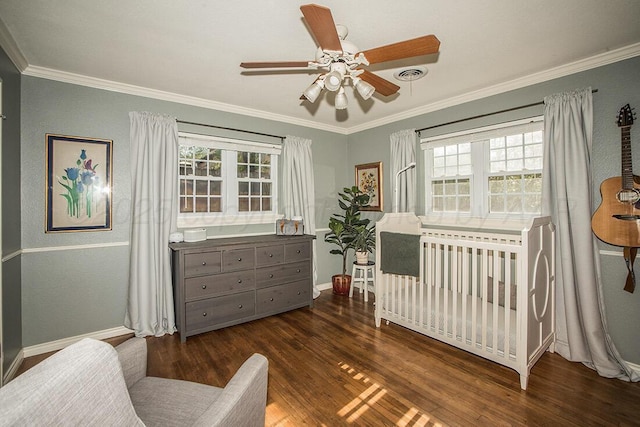 bedroom featuring ornamental molding, multiple windows, and wood finished floors