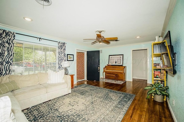 living room featuring crown molding, baseboards, ceiling fan, and wood finished floors