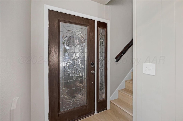 foyer with stairs and light wood-style flooring