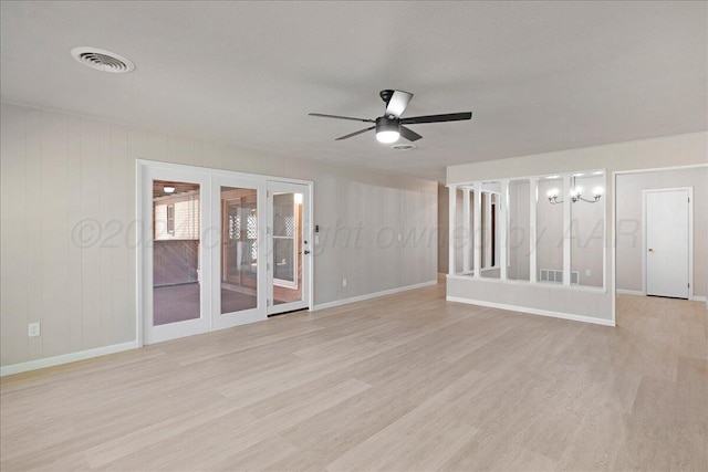 interior space with a ceiling fan, french doors, visible vents, baseboards, and light wood-style floors
