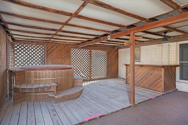 wooden deck featuring a jacuzzi