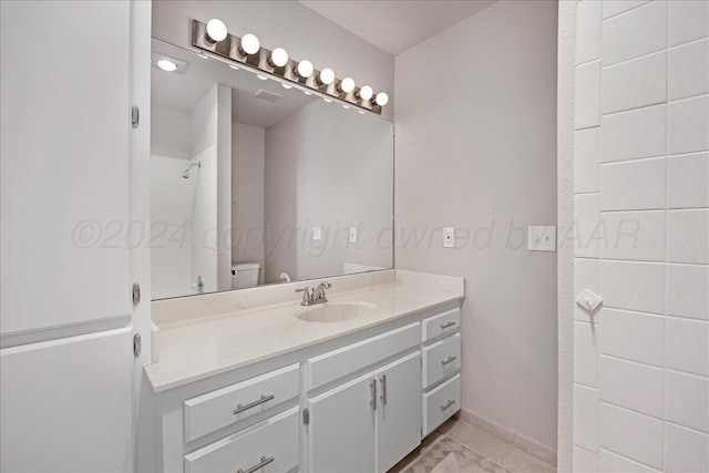 bathroom with vanity, toilet, marble finish floor, a shower, and visible vents