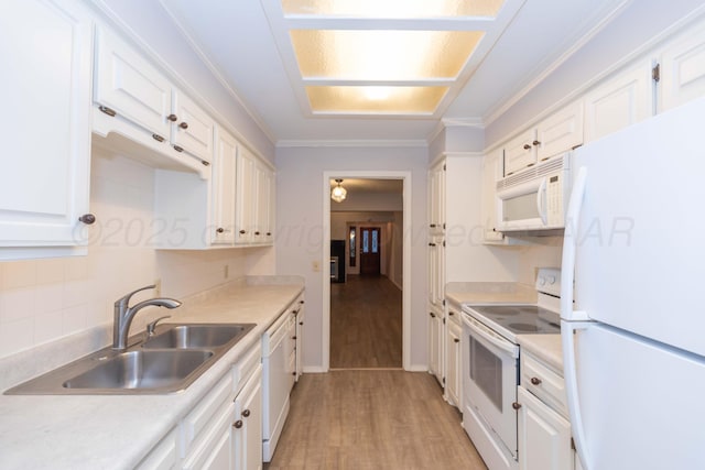 kitchen featuring white appliances, a sink, white cabinetry, light wood finished floors, and ornamental molding