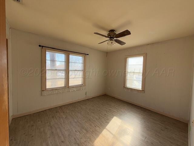 spare room with ceiling fan and light hardwood / wood-style floors