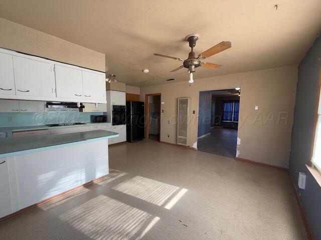 kitchen with extractor fan, white cabinets, ceiling fan, and black appliances